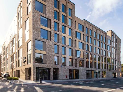 a brick building with many windows on a street at Cork Street in Dublin in Dublin