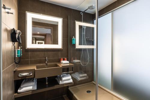 a bathroom with a sink and a shower at Novotel Paris Gare De Lyon in Paris