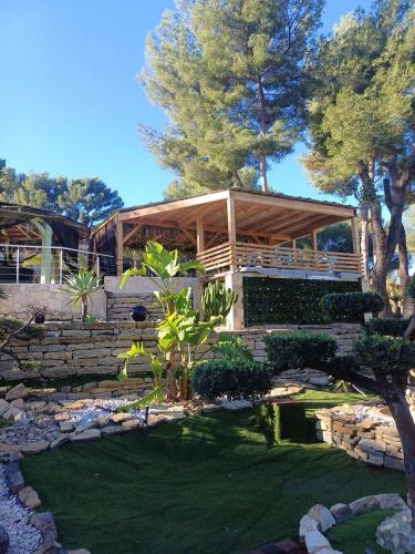 a house with a wooden deck and a yard at Boston - Loft with Jacuzzi in Sanary-sur-Mer