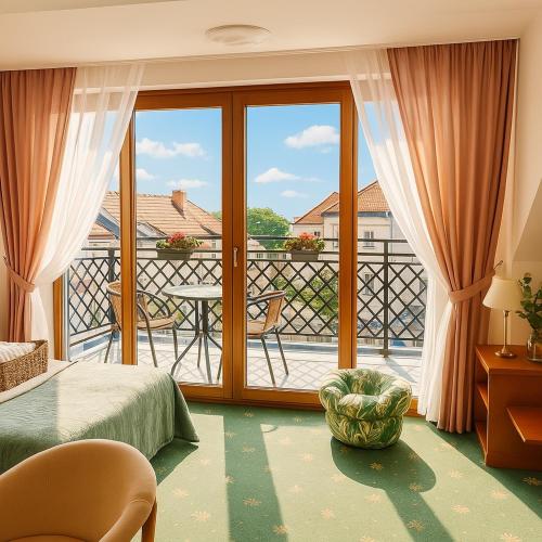 a bedroom with a bed and a balcony with a view at Apartamenty i pokoje Chaton Mielno in Mielno
