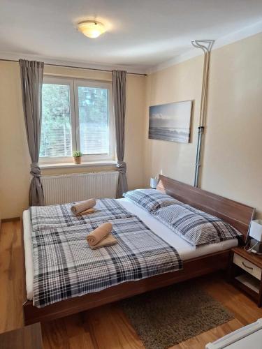 a bedroom with a bed with two towels on it at Star Apartments in Piešťany