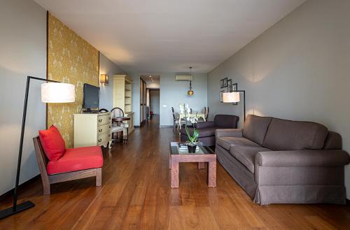 a living room with a couch and a chair at Pestana Alvor Praia Premium Beach & Golf Resort in Alvor