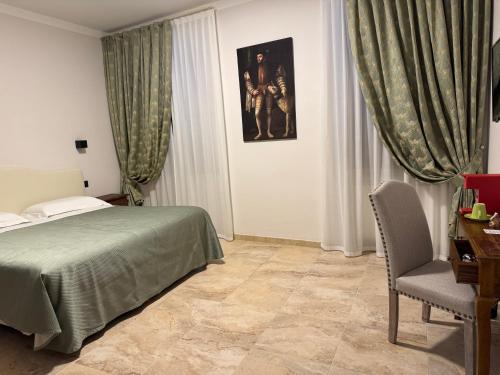 a bedroom with a bed and a chair in it at Le Camere Del Ceccottino in Pitigliano