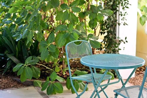 a table and two chairs and a table and a table at Fransvliet Guest House in Franschhoek