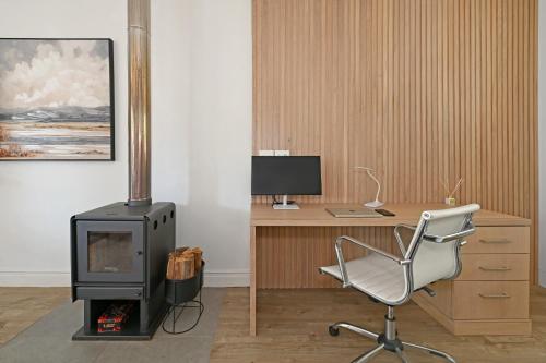 a room with a desk with a computer and a chair at Fransvliet Guest House in Franschhoek