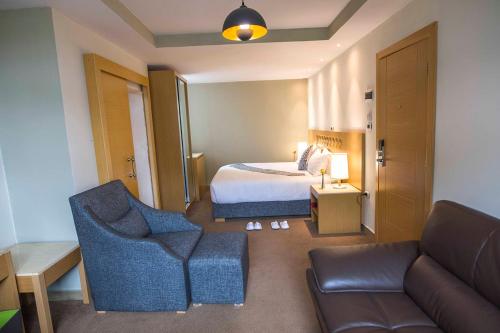 a hotel room with a bed and a couch at Vamos Addis Hotel in Addis Ababa