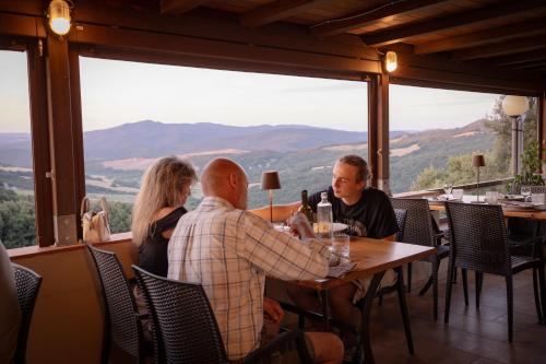 a group of people sitting at a table in a restaurant at Agriturismo San Carlo in Pomarance