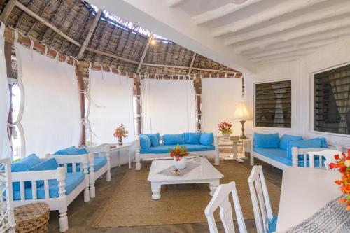 a living room with blue couches and a table at Luxury Ocean Apartment in Malindi