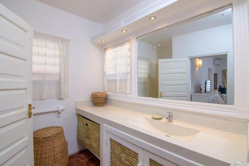 a bathroom with a sink and a large mirror at Luxury Ocean Apartment in Malindi
