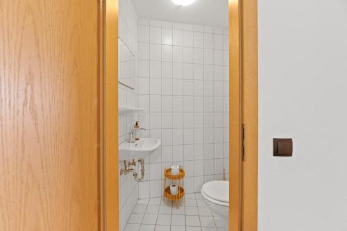a bathroom with a toilet and a sink at Steiners Hotel Airport-Messe in Birkach in Stuttgart