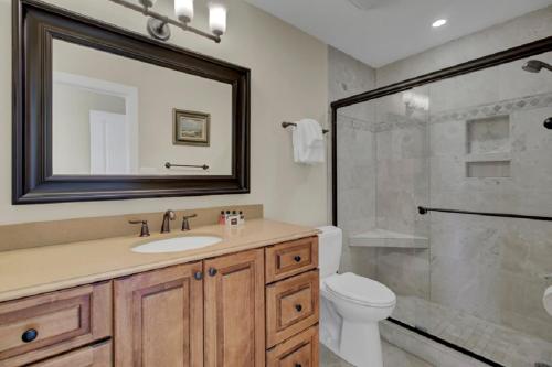 a bathroom with a toilet and a sink and a shower at Beach Club Villa 12 by Wild Dunes, Oceanfront Condo in Isle of Palms