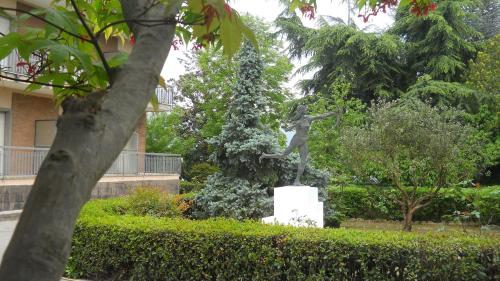 a statue of a woman standing in a garden at Hotel Diana in Cassino