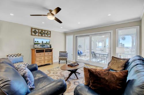 a living room with a leather couch and a table at Beach Club Villa 12 by Wild Dunes, Oceanfront Condo in Isle of Palms