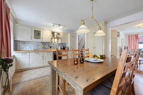 a kitchen and dining room with a wooden table at Apartment Altstadtflair in Husum