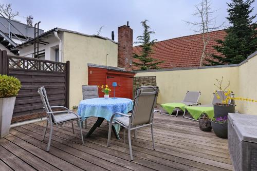 a patio with a table and chairs on a deck at Apartment Altstadtflair in Husum