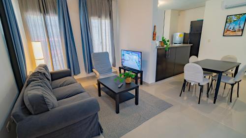 a living room with a couch and a table at Caribbean Tropical Villa - Free Electricity Included in Punta Cana
