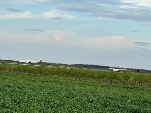 two planes are on the runway at an airport at Belgrade Airport luxury 2 room in Surčin