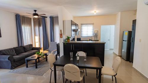 a kitchen and living room with a table and chairs at Caribbean Tropical Villa - Free Electricity Included in Punta Cana