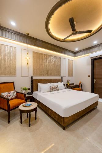 a bedroom with a large bed and a couch at Saltstayz Autograph - Connaught Place in New Delhi