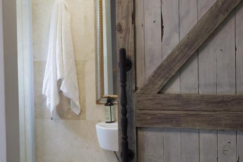 a bathroom door with a sink and a mirror at Home away from Home GuestHouse in Cape Town