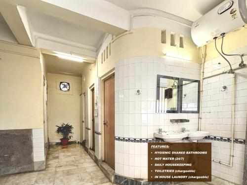 a bathroom with two sinks and a mirror at Hotel Saluja in Siliguri