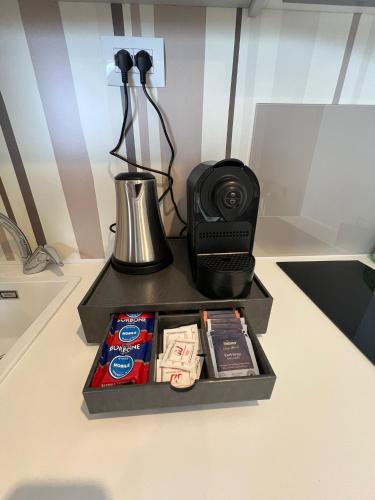 a box with a blender and other items on a table at Domvs Glamp in Baveno