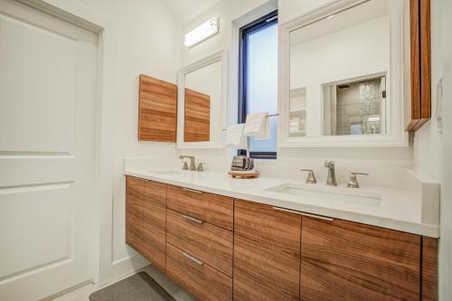 a bathroom with a sink and a large mirror at Maverick's Pool Paradise in San Antonio