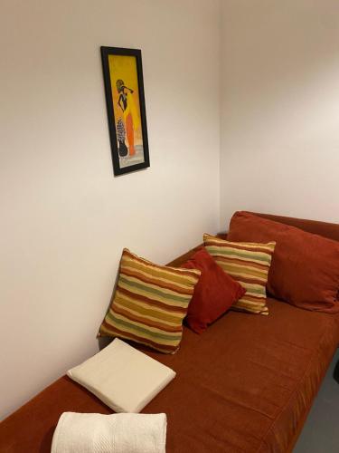 a living room with a brown couch with pillows at Departamento V&S in Posadas