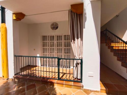 a staircase in a house with a wrought iron railing at Villa Playa in Novo Sancti Petri