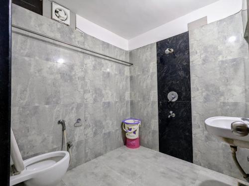 a bathroom with a toilet and a sink at Hotel Shivneri in Bilāspur
