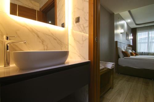 a bathroom with a white bowl sink on a counter at Grand Zara Hotel in Kayseri