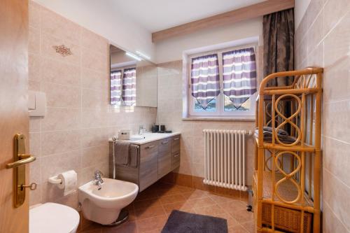 a bathroom with a sink and a toilet in it at Wiesenheim - Fewo Romantic in Trodena