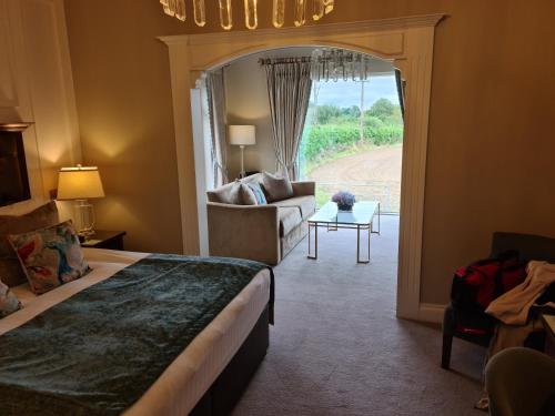a hotel room with a bed and a living room at Clanard Court Hotel in Athy