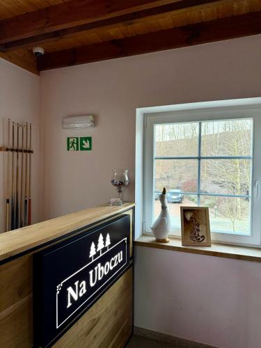 a sign on a counter next to a window at Na Uboczu in Gryfów Śląski