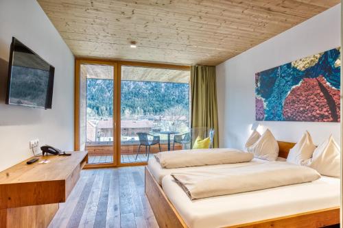 Posteľ alebo postele v izbe v ubytovaní Hotel Wirtshaus Sattlerwirt