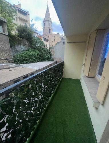 - un balcon avec un sol vert et un bâtiment dans l'établissement Le Maya Savana, à Marseille