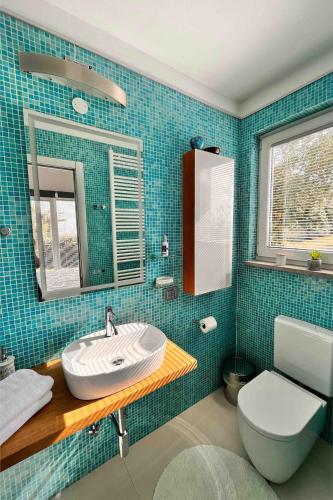 a bathroom with a sink and a toilet at SunSeaPoolsideStudio CasaSolare VistaMare in Muggia