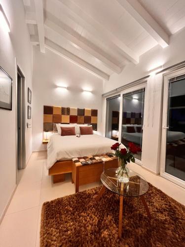 a large bedroom with a bed and a table at SunSeaPoolsideStudio CasaSolare VistaMare in Muggia