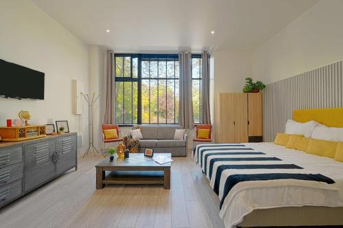 une chambre avec un grand lit et un salon dans l'établissement Cosy Studio proche gare de Lyon, à Paris