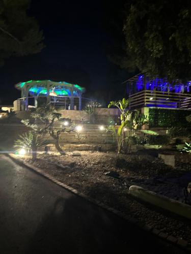 a house lit up at night with blue lights at Bentley studio in Sanary-sur-Mer