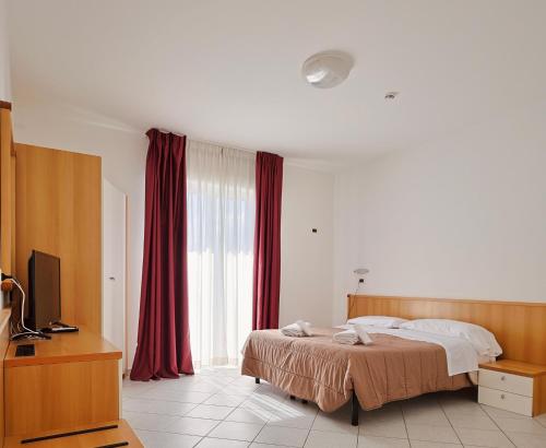 Postel nebo postele na pokoji v ubytování Hotel Felicioni