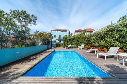 a swimming pool in the backyard of a house at HM - Porto Blue Pool Apartment in Porto
