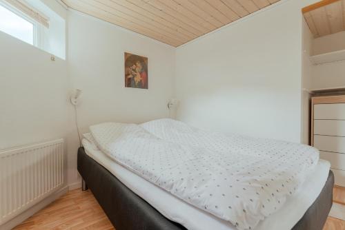 a bedroom with a white bed in a room at 1BR Apt - Peaceful Village - Parking - Nature in Hvalvík