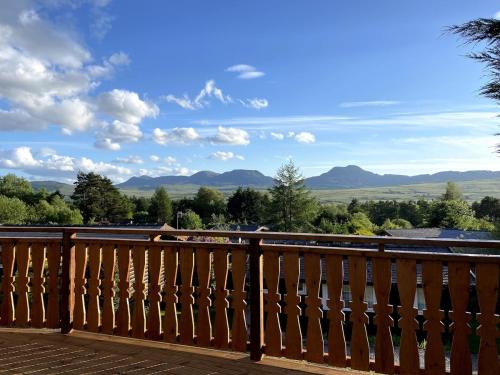 a balcony with a view of the mountains at Beautifully Restored Log Cabin in Trawsfynydd