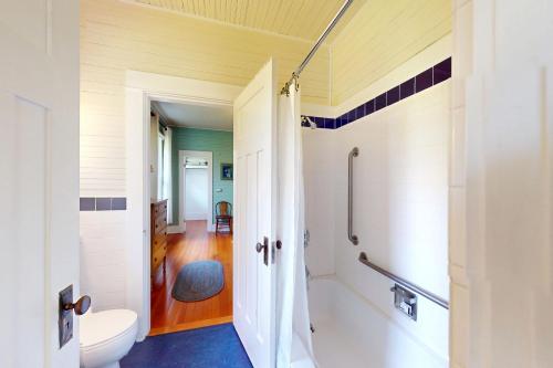 a bathroom with a shower and a toilet in it at Sunny Hill Farmhouse in Fort Ward