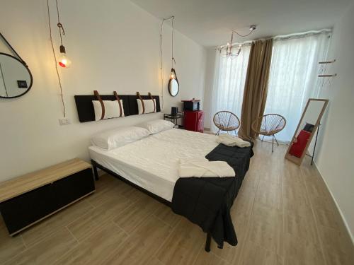 a bedroom with a large bed in a room at Isid'Oro Rooms - 100m from the sea in Sant'Isidoro