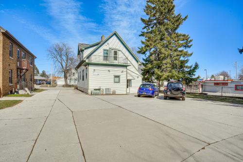a house with a blue car parked in a driveway at 2 Mi to Dtwn Studio Suite in Sheboygan in Sheboygan