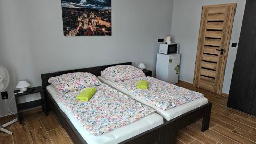 a bed with two pillows on it in a room at Ubytování Jeřábek in Lasenitz