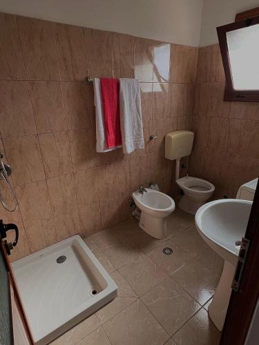 a bathroom with a toilet and a sink at Dario's Apartaments in Orikum