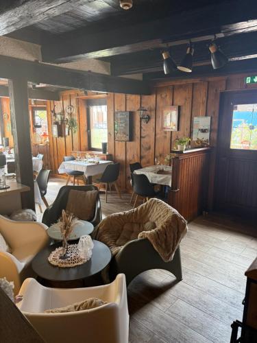 a restaurant with tables and couches and tables and chairs at Chambres - zimmer Wistub Le PasSage in Sainte-Marie-aux-Mines